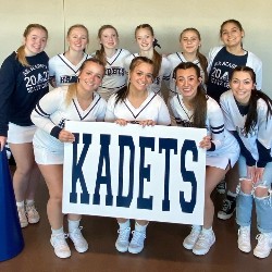 The AAHS Cheer team poses with a poster that says "Kadets".